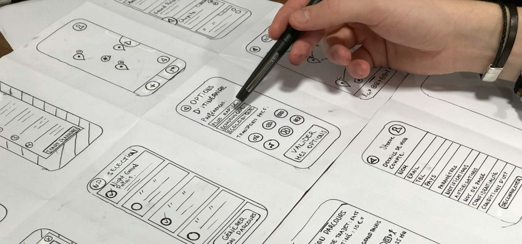 Hand sketching mobile app wireframes on paper, About Us at BURG+CO. Marketing